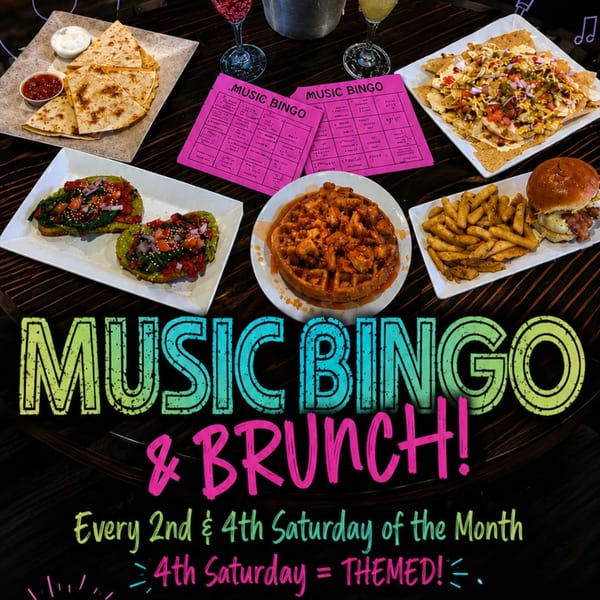 A table spread with quesadillas, avocado toast, nachos, chicken and waffles, a burger, and fries.