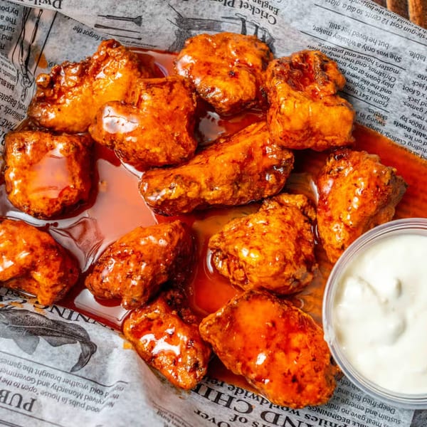 Gleasons Bar's American-style boneless wings drenched in buffalo sauce, served with a side of ranch.
