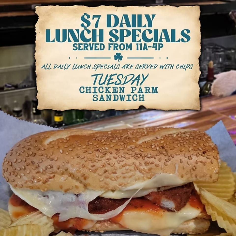 Gleasons Bar's Chicken Parm Sandwich with chips and a sign for $7 daily lunch specials.